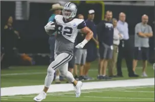  ?? The Associated Press ?? DO THE HUSTLE: Dallas Cowboys tight end Jason Witten (82) runs with the ball during an NFL training camp practice at the team’s headquarte­rs in Frisco, Texas, Monday.