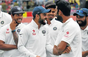  ?? /AFP ?? Controvers­ial series: India’s captain Virat Kohli, second left, enjoys a light moment with teammates after beating Australia in the fourth Test in Dharamsala on Tuesday.