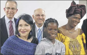  ?? AP ?? Janet Sylva (second from right) and her mother, Philomena, (right), meet with surgeons at Cohen Children’s Medical Center in New Hyde Park, N.Y., on Thursday.