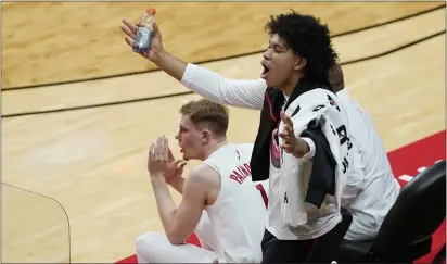  ?? KATHY WILLENS — THE ASSOCIATED PRESS ?? Rutgers guard Ron Harper Jr., who sat out the game with an ankle injury, yells from the bench as a Purdue player shoots a free throw during the second half of a game on Tuesday in Piscataway.