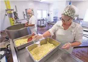  ?? MARK HOFFMAN / MILWAUKEE JOURNAL SENTINEL ?? Terry (left) and Denise Woods make cheese this month on their farmstead, Highland Farm Creamery in Walworth. The Woods milk 10 cows other farm and make six different cheeses.