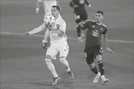  ?? ASSOCIATED PRESS ?? REAL MADRID’S LUCAS VAZQUEZ (left) vies for the ball with Celta Vigo’s Lucas Olaza during the Spanish La Liga soccer match between Real Madrid and Celta Vigo at the Alfredo Di Stefano stadium in Madrid, Spain Saturday.