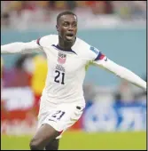  ?? Associated Press ?? Tim Weah, of the United States, celebrates after scoring during the World Cup Group B soccer match against Wales, Monday, at the Ahmad Bin Ali Stadium in Doha, Qatar. The two teams ended in a 1-1 draw.