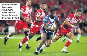  ??  ?? Huddersfie­ld’s Jermaine McGillvary takes on the Tonga defence for Great Britain