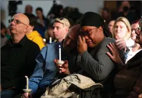  ?? (AP/The Gazette/Parker Seibold) ?? Tyrice Kelley (center right), a performer at Club Q, is comforted Sunday during a service held at All Souls Unitarian Church following a deadly overnight shooting at the gay nightclub in Colorado Springs, Colo.