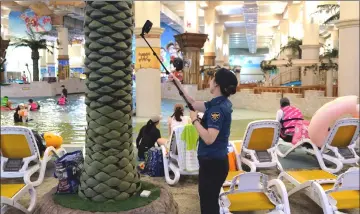  ??  ?? A police officer uses a detector to search for hidden cameras at a public pool in Bucheon, on the outskirts of Seoul.
