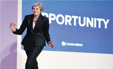  ?? GETTY IMAGES ?? British PM Theresa May dances onto the stage Wednesday, a way of declaring she won’t back down to critics of her Brexit schemes. Many think her speech’s attempt to soothe anxiety at the Conservati­ve Party conference will help keep her in office — at least for the next six months.