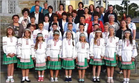  ?? Photo by Michelle Cooper Galvin ?? Children from Chernobyl with members of their host families of The Friends of the Children of Chernobyl Rathmore Branch at the 21st Anniversar­y Mass in Rathmore Church on Wednesday.