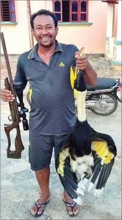  ?? SUPPLIED ?? Kruy Chamroeun was summoned for questionin­g by authoritie­s after a picture of him holding a hornbill was posted on Facebook.