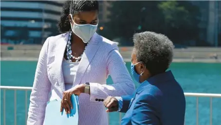  ?? TERRENCE ANTONIO JAMES/CHICAGO TRIBUNE ?? Cook County State’s Attorney Kim Foxx, left, and Chicago Mayor Lori Lightfoot bump elbows after holding a news conference together in 2020.