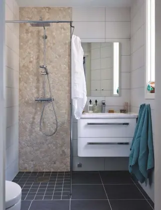  ??  ?? SHOWER ROOM
Simply styled with bold black floor tiles and white walls, this compact room (left) was designed by the previous owners. Similar tumbled stone tiles, Tumbled interlocki­ng marble wall tiles, £28.99sq m, Marblemosa­ics, marble-mosaics.com....