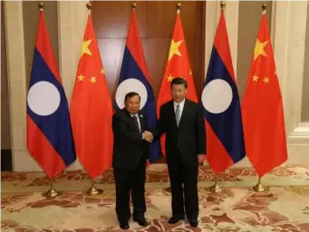  ?? (Reuters) ?? Laos’s President Bounnhang Vorachith (left) and Chinese President Xi Jinping before a bilateral meeting at Diaoyutai State Guesthouse earlier this month