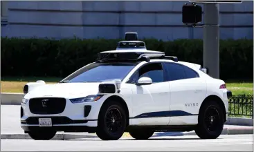  ?? PHOTOS BY JIM WILSON — THE NEW YORK TIMES ?? A Waymo self-driving car on the street in San Francisco on Monday. Local officials are worried that state regulators are too eager to agree to a plan to offer round-the-clock driverless taxi services.