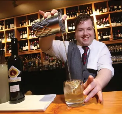  ?? VINCE TALOTTA PHOTOS/TORONTO STAR ?? Bartender Kyle Burch making the Last Minute Lulu, a low-alcohol cocktail with sherry at Cava restaurant.