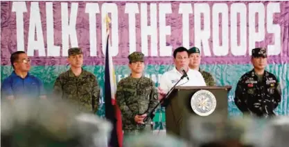  ?? ?? JOLO: Philippine­s’ President Rodrigo Duterte gives a speech to soldiers of the Joint Task Force (JTF) Sulu at Camp Teodulfo Bautista on Saturday. — AFP