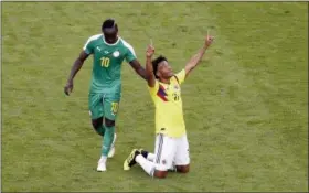  ?? GREGORIO BORGIA — THE ASSOCIATED PRESS ?? Colombia’s Juan Cuadrado, right, celebrates after winning the group H match between Senegal and Colombia, as Senegal’s Sadio Mane touches him, at the 2018 soccer World Cup in the Samara Arena in Samara, Russia, Thursday.