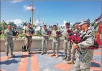  ??  ?? Piper Stirton instructin­g the Colombian pipe band in the Carribean sun.