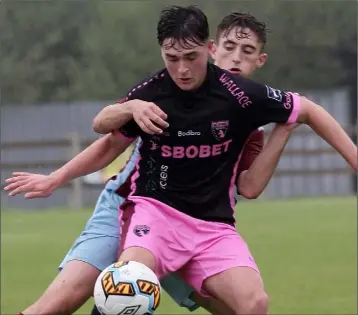  ??  ?? Jack Healy uses his strength to hold off a Cobh Ramblers opponent during Sunday’s clash.