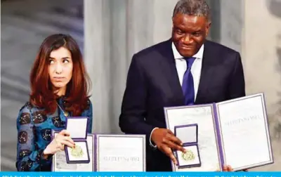  ??  ?? OSLO: Nobel Peace Prize laureates Yazidi activist Nadia Murad and Congolese doctor Denis Mukwege pose with their Nobel Peace Prizes during the award ceremony yesterday at the City Hall. — AFP