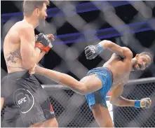  ??  ?? Neil Magny, right, lands a kick on Albuquerqu­e’s Carlos Condit during their fight in December. Condit, who lost the fight, is unsure if he’ll fight again after losing four straight bouts.