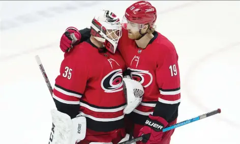  ?? ADRIAN WyLD/THE CANADIAN PRESS ?? Hurricanes defenceman Dougie Hamilton congratula­tes goalie Curtis McElhinney after their win against the Ottawa Senators Tuesday. The team has skated its way into playoff contention.