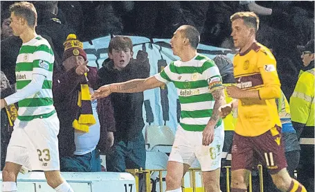  ?? Picture: SNS. ?? Scott Brown throws a coin on to the trackside during Wednesday’s league meeting at Fir Park.