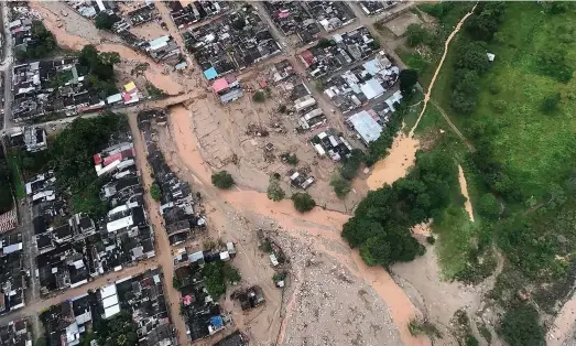  ??  ?? above An aerial view is seen Saturday of Mocoa, Colombia, after an avalanche of water from an overflowin­g river swept through the city as people slept. The incident triggered by intense rains left at least 193 people dead in Mocoa, located near...