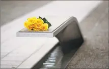  ?? Patrick Semansky / Associated Press ?? Flowers rest on a bench bearing a name in memory of retired U.S. Army Lt. Col. Gary Smith before a ceremony in observance of the 18th anniversar­y of the Sept. 11attacks at the Pentagon in Washington on Wednesday.