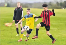  ??  ?? Action from the Downs League Division Two game between St Andrews (yellow shirts) and Lion, which finished 2-2