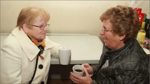 ??  ?? Eithne Dempsey and Geraldine Redmond having a chat over a cuppa at the annual Christmas market in Ballygarre­tt parish hall.