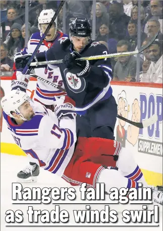  ?? USA TODAY Sports ?? KNOCKED AROUND: Jesper Fast is knocked to the ice by Ben Chiarot during the first period of the Rangers’ 4-3 loss to the Jets on Tuesday night.