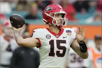  ?? LYNNE SLADKY — THE ASSOCIATED PRESS ?? Georgia quarterbac­k Carson Beck (15) stands back to pass during the first half of Orange Bowl NCAA college football game against Florida State, Saturday, Dec. 30, 2023, in Miami Gardens, Fla.