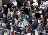  ?? THE ASSOCIATED PRESS ?? Travelers line up at a security checkpoint area in Terminal 3 at O’Hare Internatio­nal Airport in Chicago on Nov. 29, 2015. The auto club AAA said Tuesday that it expects 1 million more Americans to venture at least 50 miles from home, a 1.9 percent...