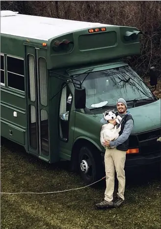  ?? SUBMITTED PHOTO ?? Michael Burlotos, 25, of Chadds Ford, and his Siberian husky, Bailey, with the converted school bus he uses to travel around the country.