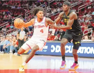  ?? ERIC CHRISTIAN SMITH / ASSOCIATED PRESS ?? Houston Rockets guard Jalen Green (4) drives to the basket as Utah Jazz forward Taylor Hendricks defends during Saturday’s game in Houston.