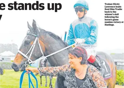  ??  ?? Trainer Kirsty Lawrence leads Real Slim Tradie back to the winner's stall following the horse's game maiden victory at Hastings.