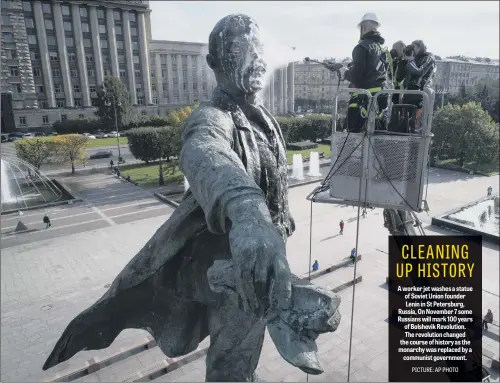  ??  ?? A worker jet washes a statue of Soviet Union founder Lenin in St Petersburg, Russia, On November 7 some Russians will mark 100 years of Bolshevik Revolution. The revolution changed the course of history as the monarchy was replaced by a communist...