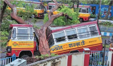  ?? PHOTO: PTI ?? Mangled remains of a bus after a tree fell on it, in Kolkata on Thursday