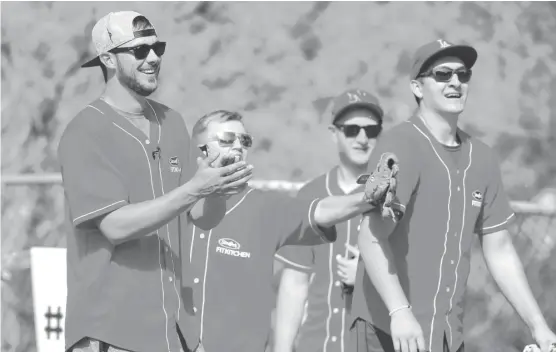  ?? | RICK SCUTERI/AP ?? The Cubs’ Kris Bryant (left) cheers on the intramural team he “coached” at Arizona State University during the Stouffer’s Fit Kitchen softball game March 21.