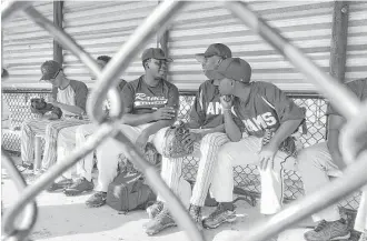  ?? Hunter Atkins photos / Houston Chronicle ?? Ernest Nixon, center left, engages in some dugout chatter with his baseball teammates for Palm Beach Lakes Community High School, whose median household income is less than $33,000.