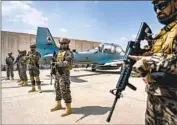  ?? Marcus Yam Los Angeles Times ?? TALIBAN FIGHTERS secure Hamid Karzai Internatio­nal Airport in Kabul, Afghanista­n, last August.
