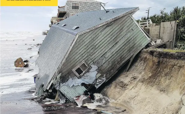  ?? GARY LLOYD MCCULLOUGH / THE FLORIDA TIMES-UNION VIA THE ASSOCIATED PRESS ?? The wreckage of a house sits half in the Atlantic Ocean on Monday in the aftermath of Hurricane Irma in Ponte Vedra Beach near Jacksonvil­le in northern Florida.