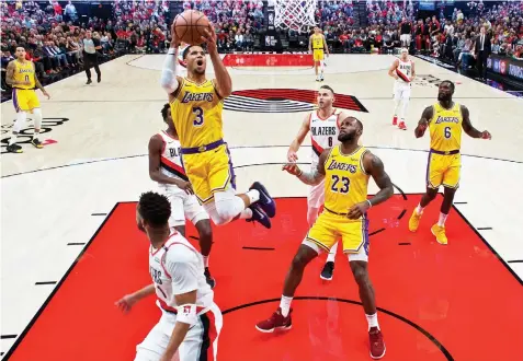  ?? ASSOCIATED PRESS ?? Los Angeles Lakers guard Josh Hart, top, shoots over Portland Trail Blazers guard Evan Turner during the first half of an NBA basketball game in Portland, Ore.