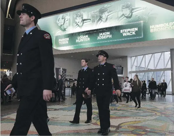  ?? DAVID BLOOM ?? Photograph­s of Edmonton-area Humboldt Broncos players Jaxon Joseph, Logan Hunter, Parker Tobin and Stephen Wack are projected onto an overhead screen Tuesday as people enter Rogers Place for a public memorial for the four young men killed in the April...