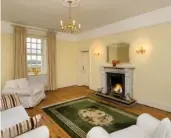  ??  ?? Bright living room with fireplace.