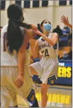  ?? COURTESY JOHN DENNE ?? Peñasco’s Martina Tafoya eyes the basket as she goes up for a shot during first half action against the Questa Wildcats on Friday evening in Peñasco. Tafoya, a guard, contribute­d 15 points in the 71-36 victory, including three 3-pointers.