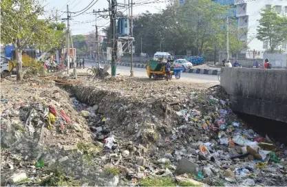  ??  ?? BANGALORE: This photo taken on January 10, 2017 shows garbage clogging up a storm water drain in Bangalore. — AFP