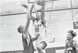  ?? JIM DONNELLY/COURTESY ?? Blanche Ely’s Joshua Scott (15) drives to the basket against Stranahan’s Inady Legiste during the 29th annual Kreul Classic in Coral Springs.
