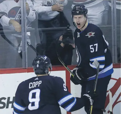  ?? KEVIN KING ?? Winnipeg Jets defenceman Tyler Myers celebrates his goal with Andrew Copp during Game 2 against the Minnesota Wild Friday in Winnipeg. The Jets went on to record a 4-1 victory to take a 2-0 lead in the best-of-seven series, which shifts to St. Paul,...