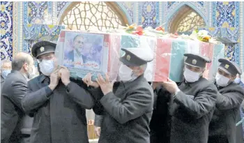  ?? — AFP photo ?? Servants of the holy shrine of Imam Reza carrying the coffin of Fakhrizade­h during his funeral procession in the northeaste­rn city of Mashhad.